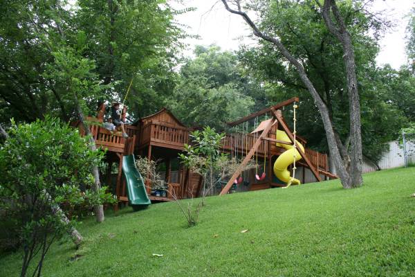 unique playset spaces, backyard playground built on slope with bridges and zip line