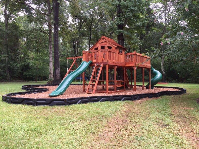 One of our many redwood playsets, this Backyard Fun Factory Fort Stockton swing set design features a tree deck, two slides, swings, and more.