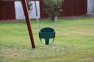 green infant full bucket swing with plastisol coated chain on a wooden swing set
