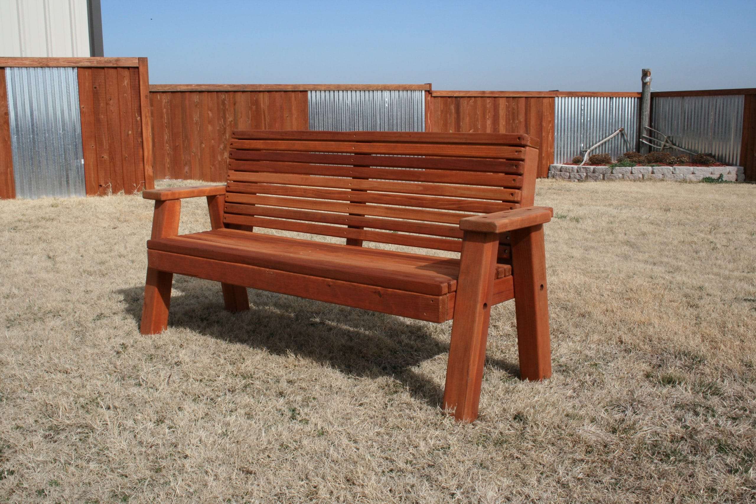 five foot redwood park bench shown in yard