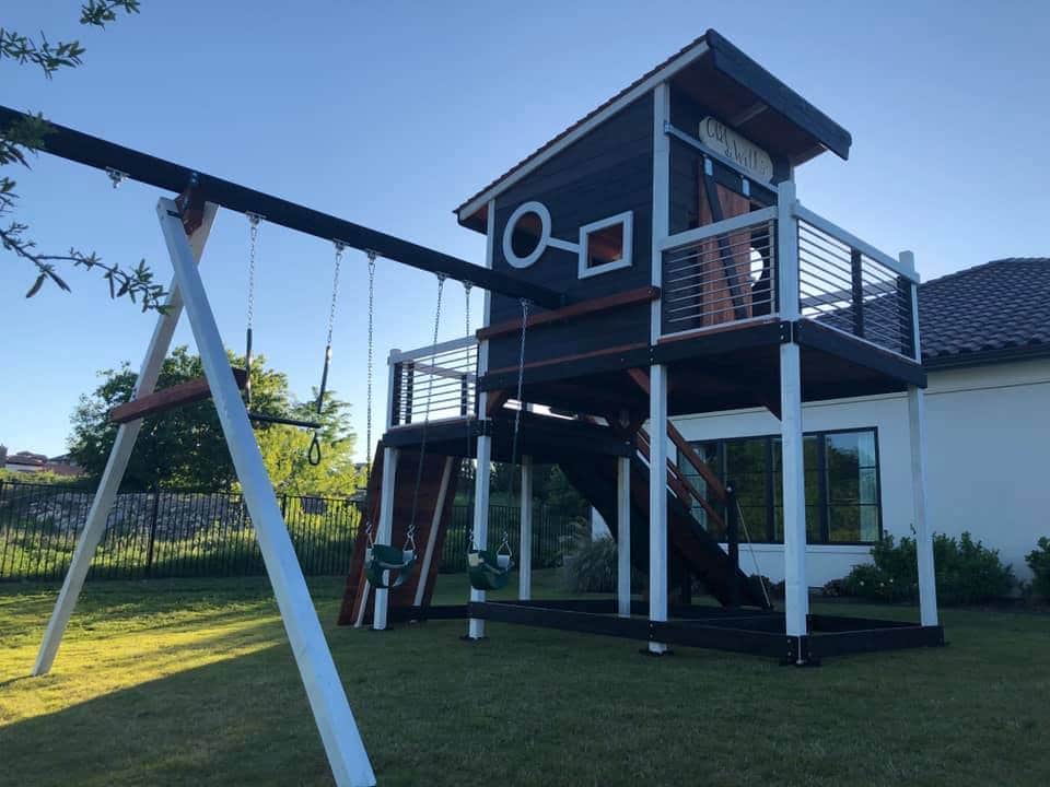 this modern design playset is accessorized with toddler swings, trapeze bar and air pogo swing and a rock wall climber.