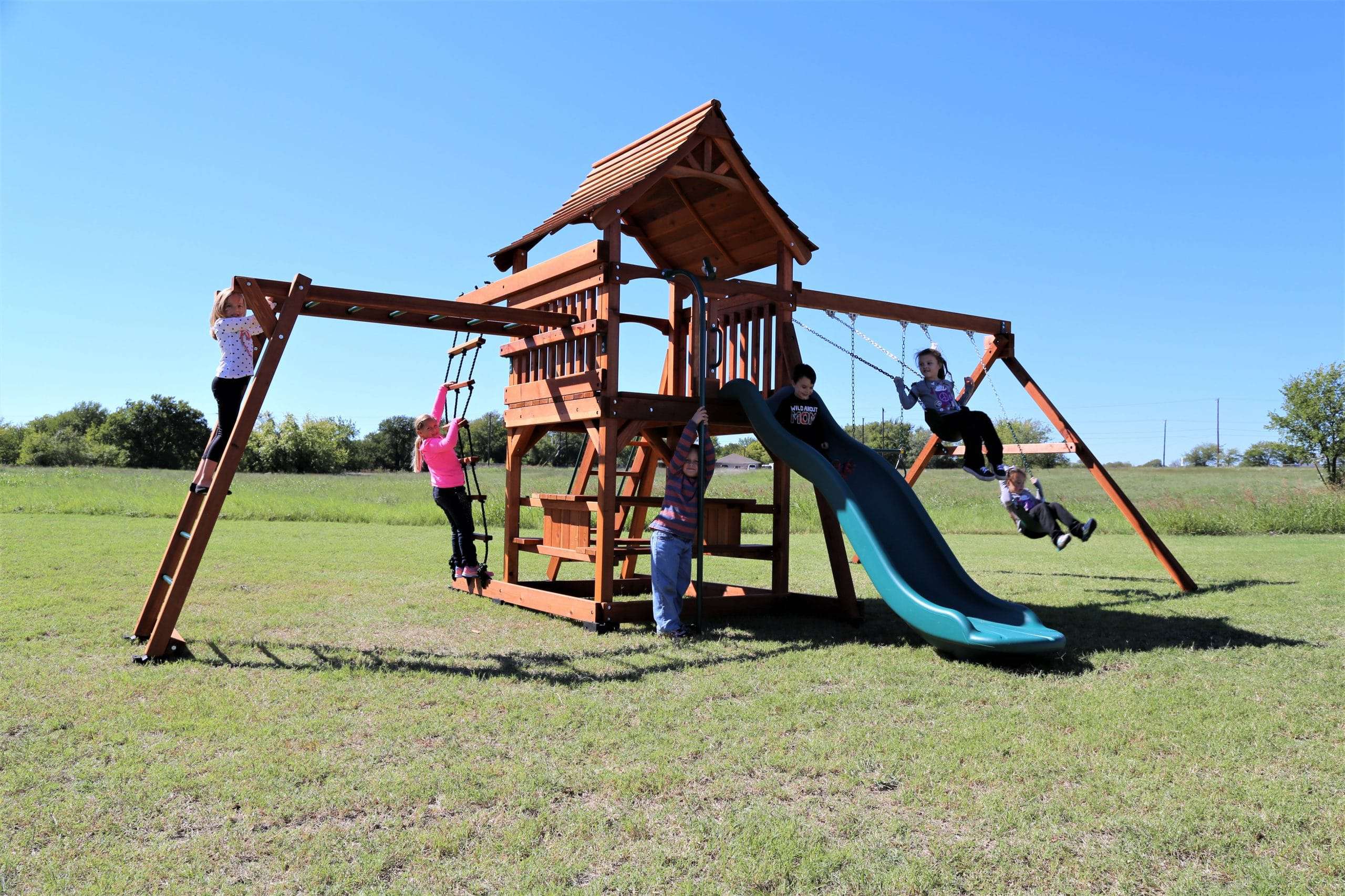 Waxahachie, Texas, fun shack swing set with monkey bars rope ladder climber picnic table swings and slide