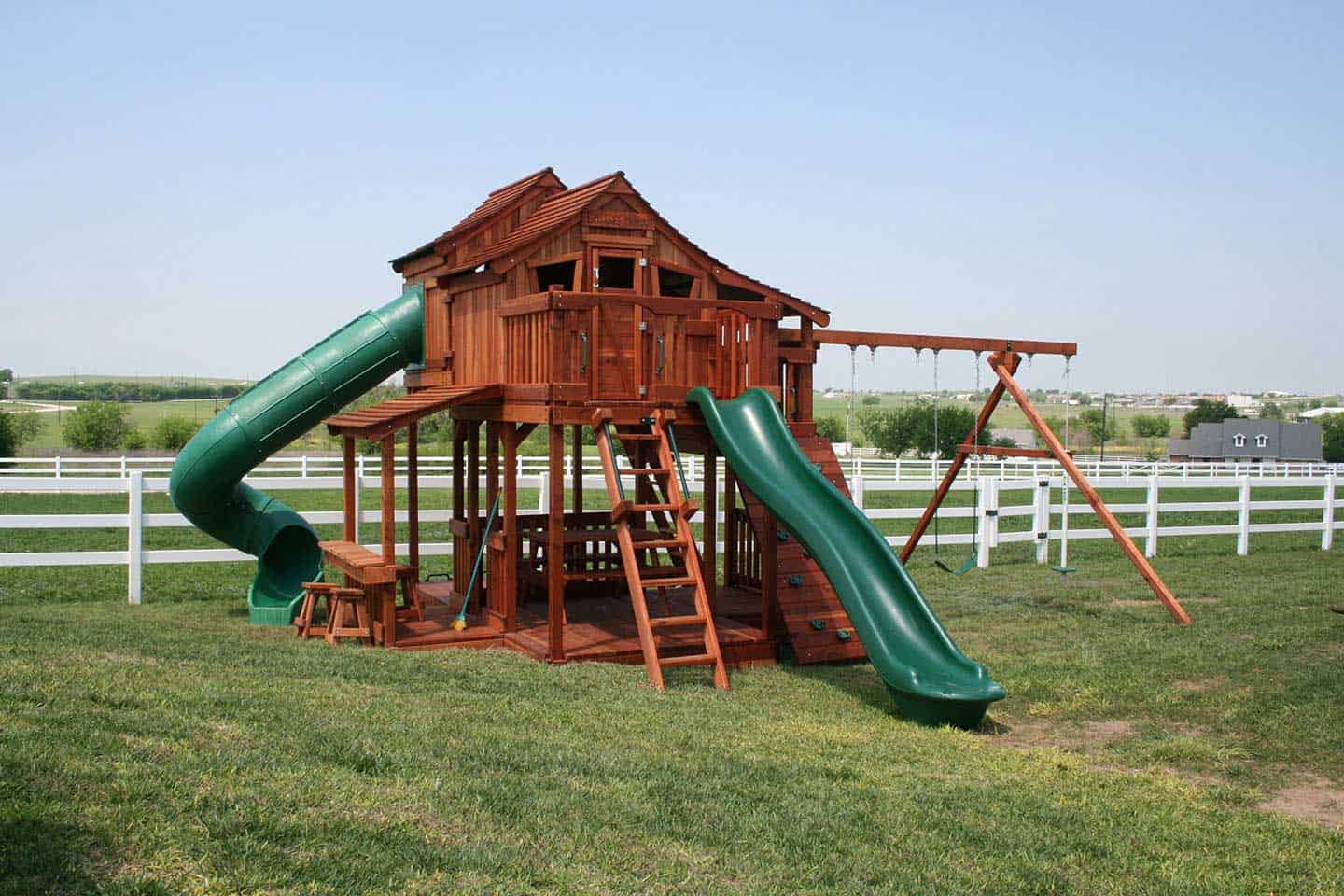 Waxahachie, Texas, Fort Stockton Tri-Level swing set with multi levels for children to play. Upper cabins, open slide, spiral slide, lemonade stand and swings.