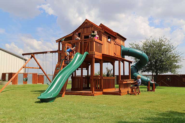 Weatherford, Texas, Ticonderoga Tri-Level, redwood wooden forts, twister slide, swings, rave slide, and rock wall