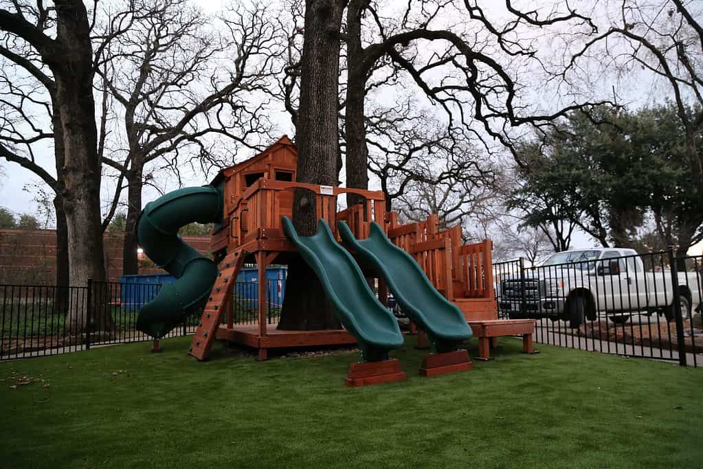 kids forts with tree decks, Fort Stockton playset with extended tree deck, platform stairs, slides and climbers
