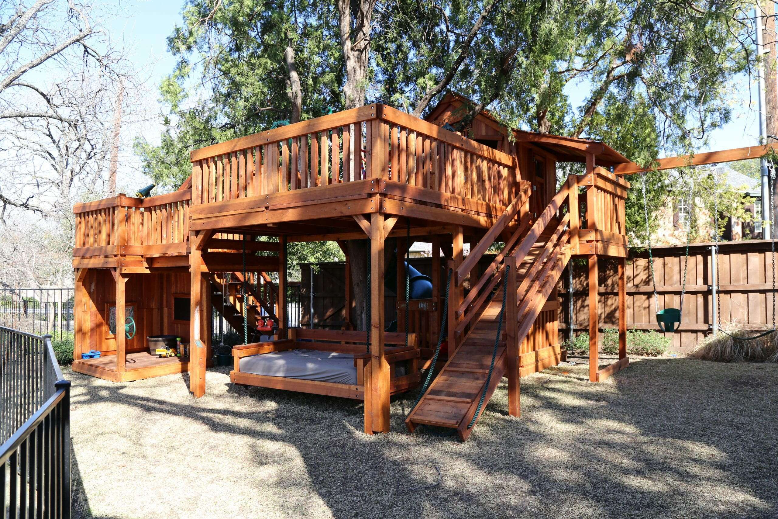 River Oaks, Texas, redwood swingset with daybed, stage and fort