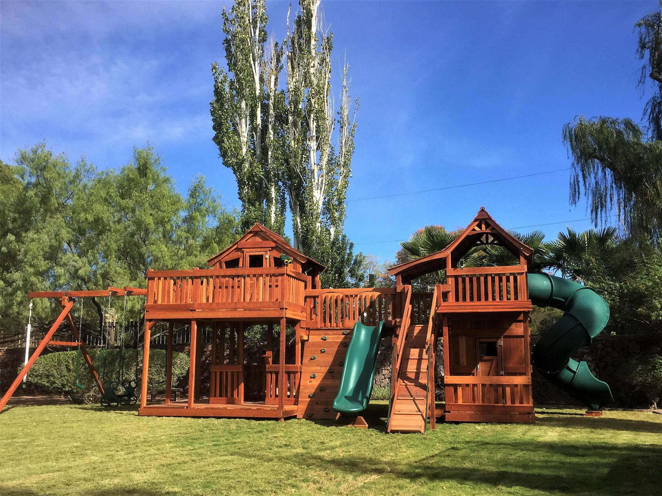 ruidoso, new mexico, backyard bridged playset with open slide and swings