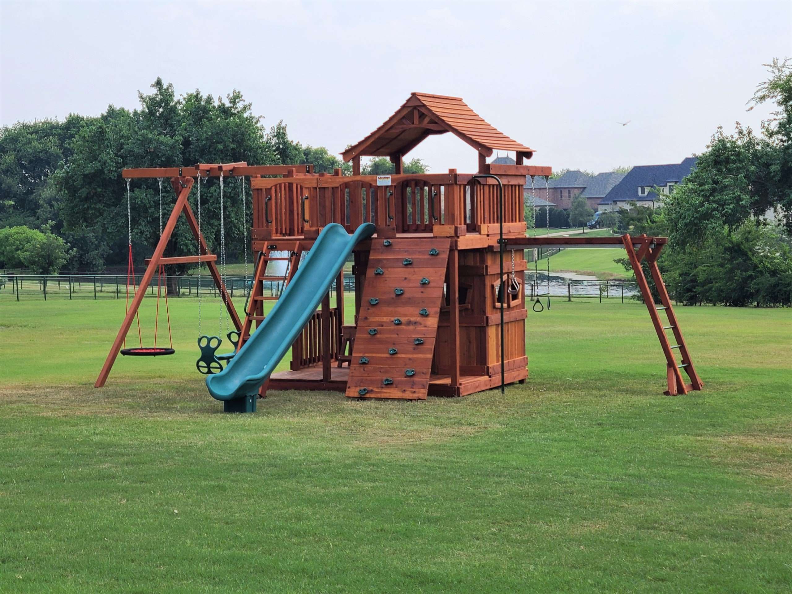 Dallas Fort Worth Texas, Montgomery, Texas, fort stockton with overhead climber swing set with upper wrap around deck, lower cabin rock wall