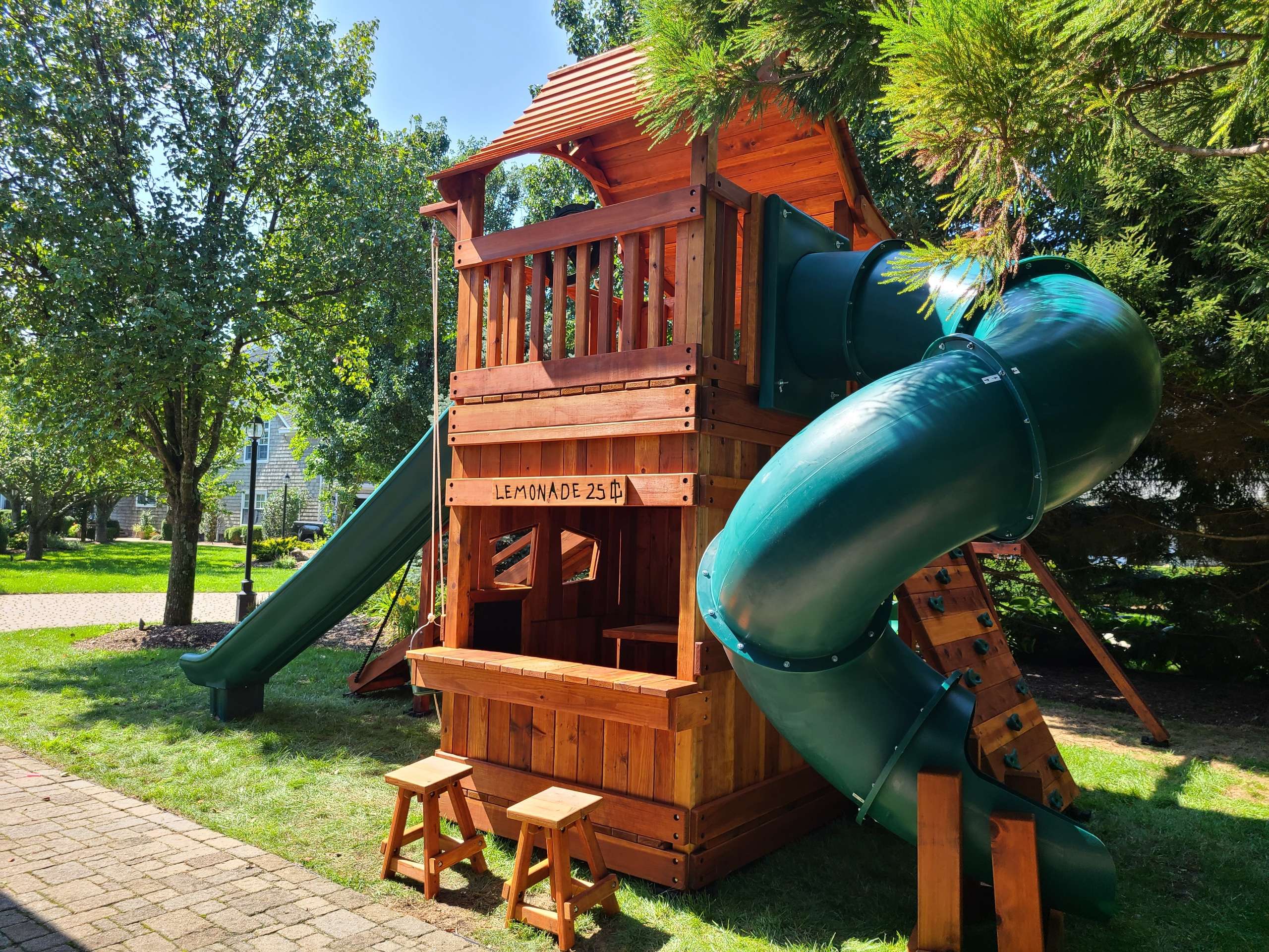 River Oaks, Texas, redwood playset in unique space, mustang 7 foot level playset with lower cabin, slide, adventure ramp, spiral slide and swings in small space