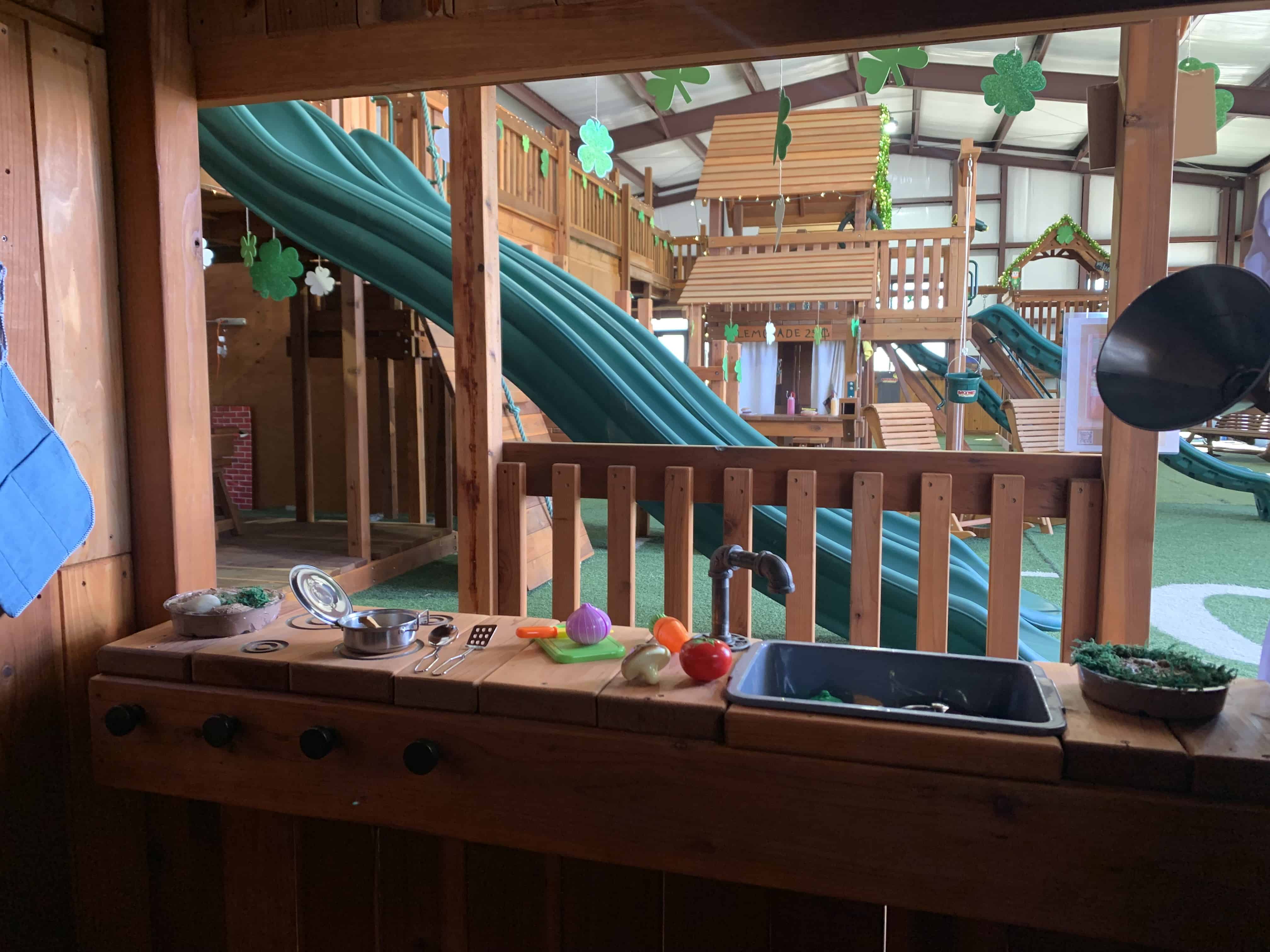 mud kitchen inside playset cabin at our swing set showroom in fort worth