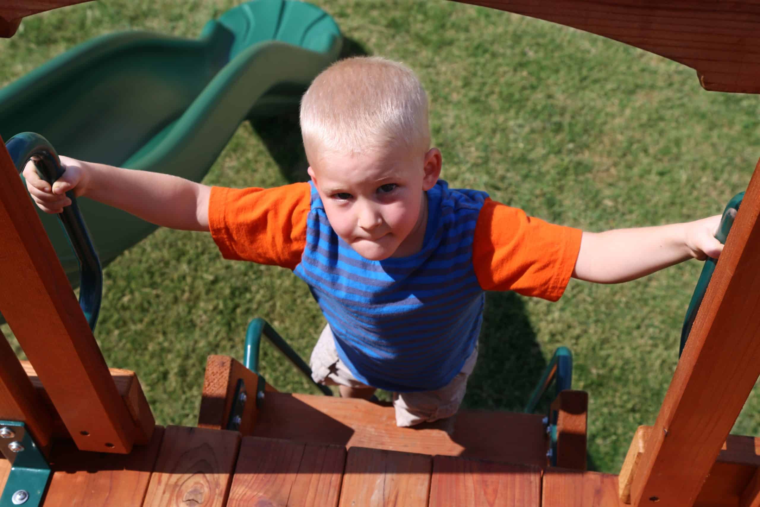 Swing Set Keller, Texas, young boy climbing deck ladder on backyard playset