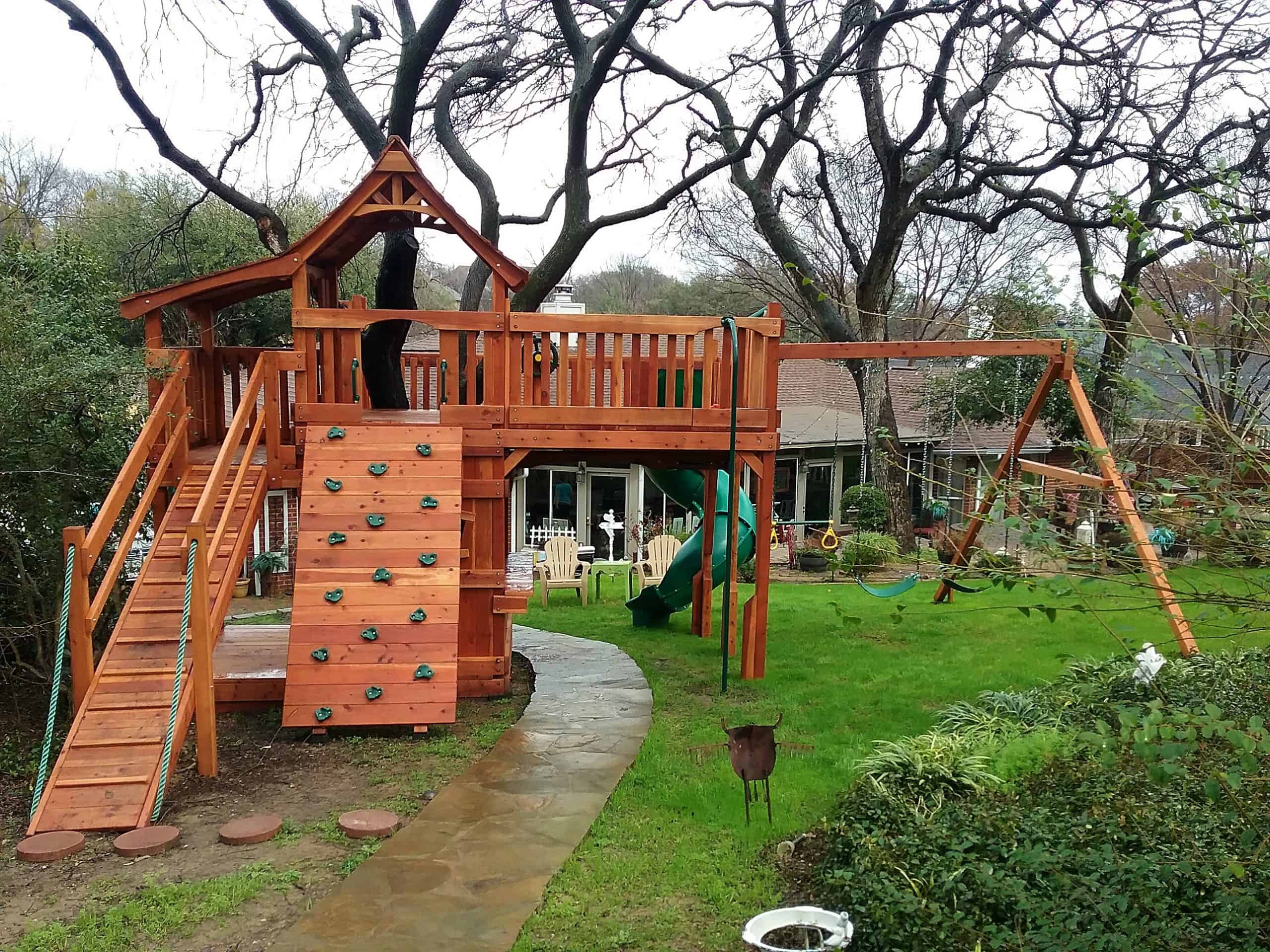 Decatur Texas wooden swing set for children with rock wall and ramp