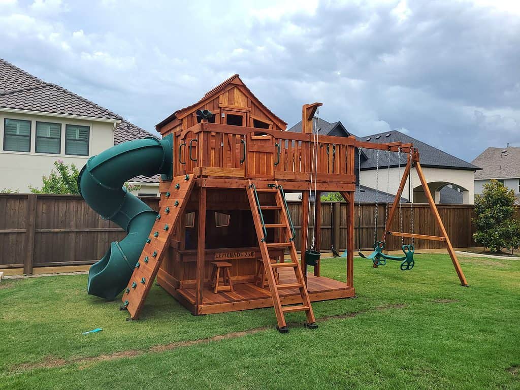 Flower Mound, fort stockton playset with lemonade counter, spiral slide, swings, lower cabin and upper cabin. catalog