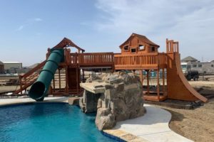 Trophy Club, Texas, redwood playset, green tube slide into pool, Fort Stockton bridged to open fort