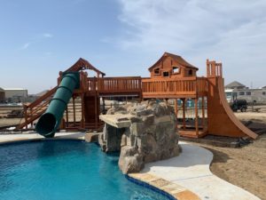 Trophy Club, Texas, redwood playset, green tube slide into pool, Fort Stockton bridged to open fort