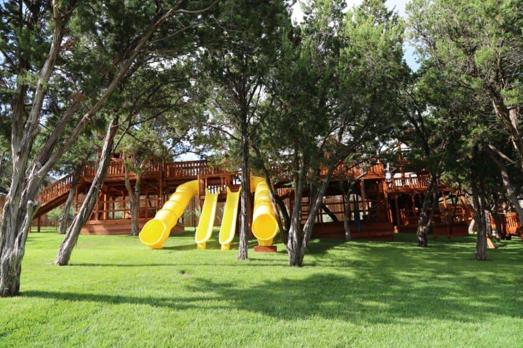 san antonio, texas custom swing set, massive multi-tower bridged playset with yellow slides