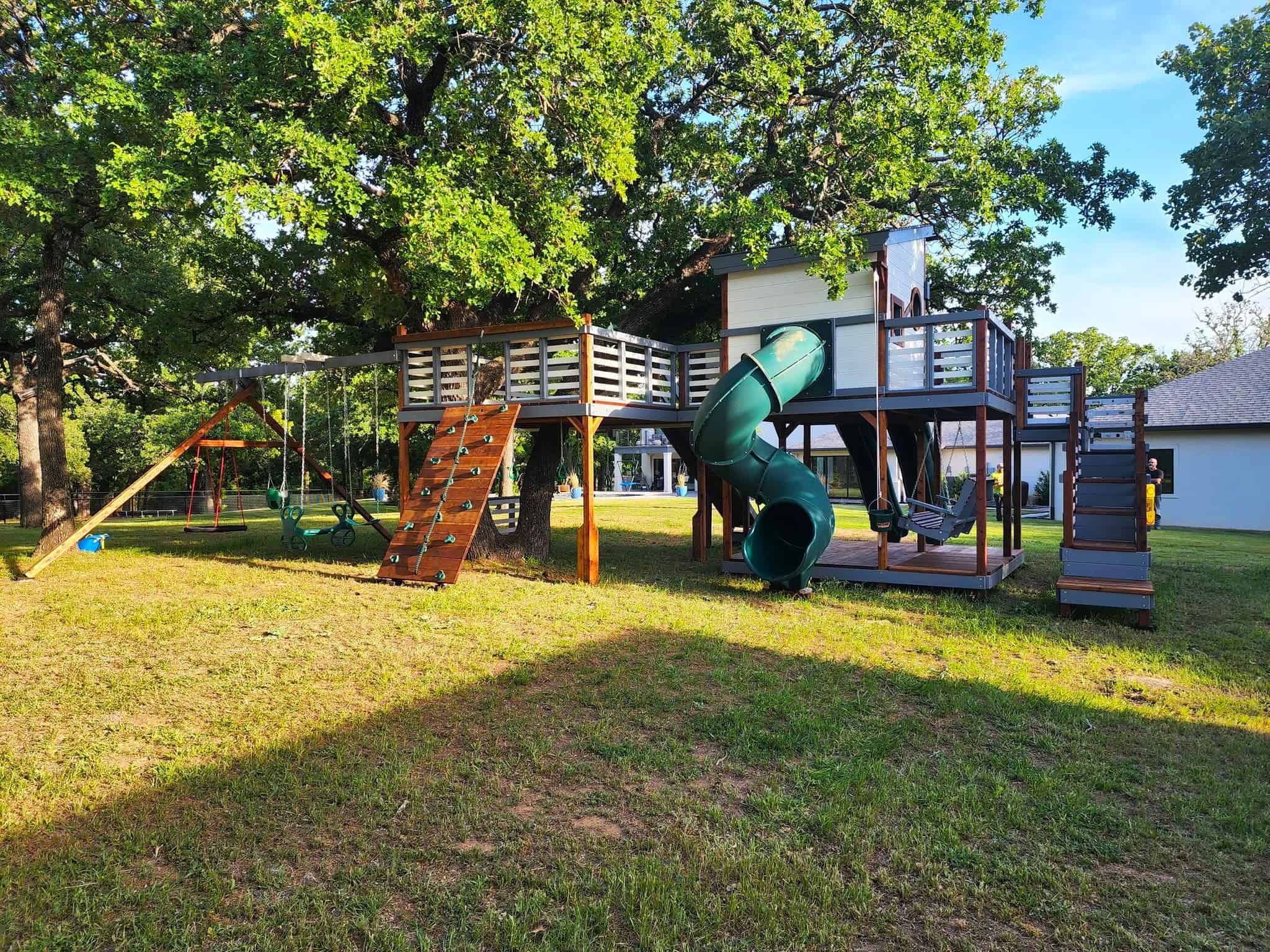 modern swing set, kids fun spiral slide, rock climbing wall with rope, swings including adult porch swing