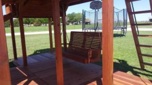 adult porch swing under playset