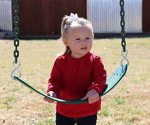 highland village, texas, little blonde girl with red shirt holding green belt swing in backyard