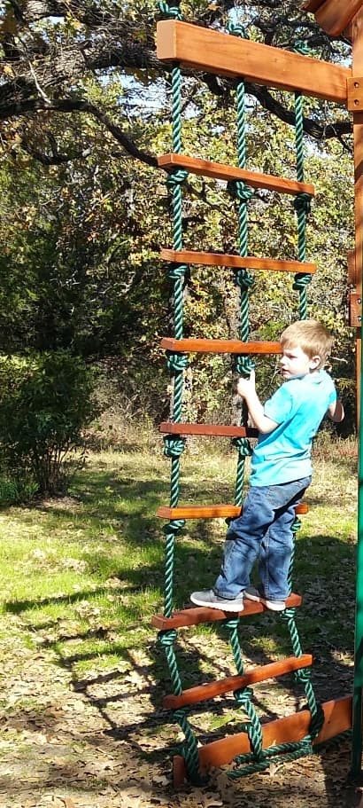 Lewisville, Texas, rope ladder climbing accessory for playset with little boy climbing the ladder rungs