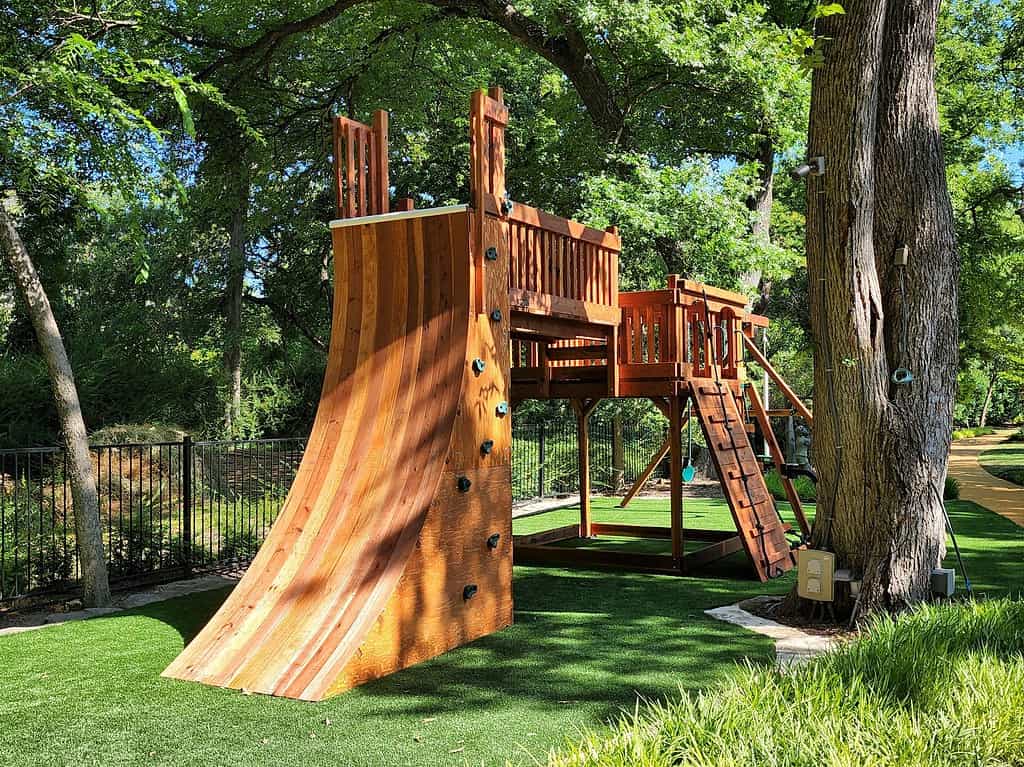 grapevine, texas, warp wall play accessory bridged to open deck with swings and climbers Older children love this add-on