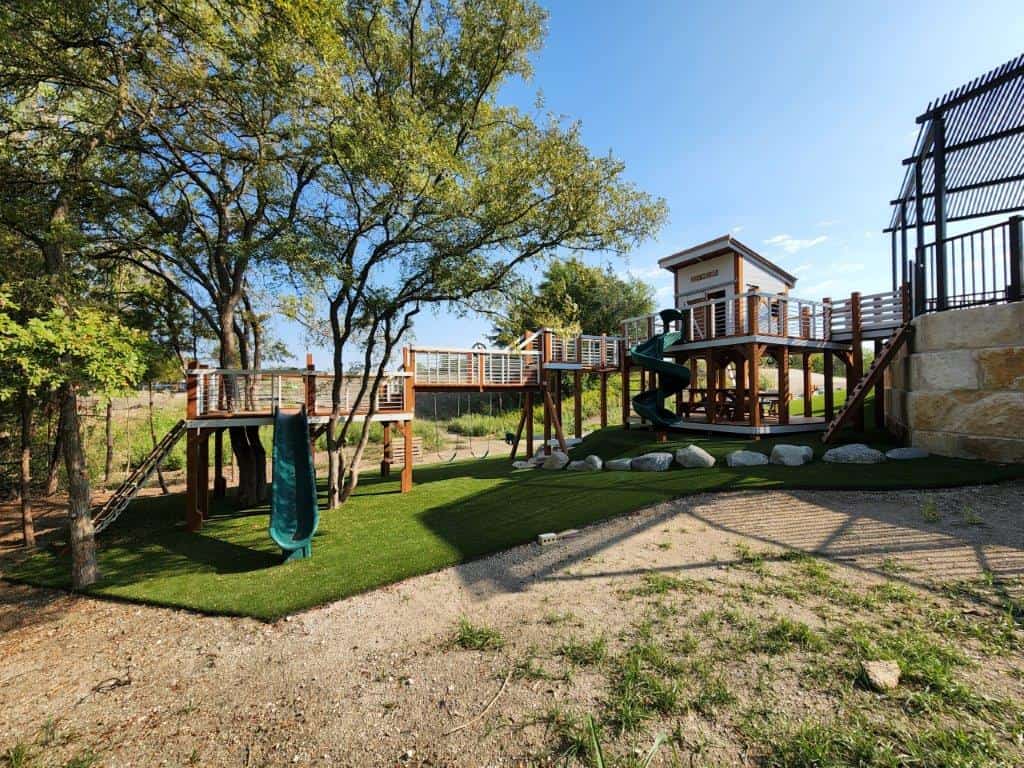 modern design playset, contemporary playset bridged from elevated patio to tree deck. constructed with 6x6 posts.