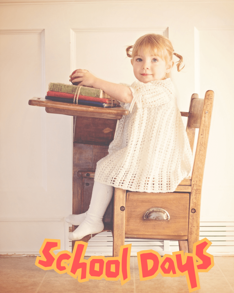 School Days picture of little girl sitting on an old school desk