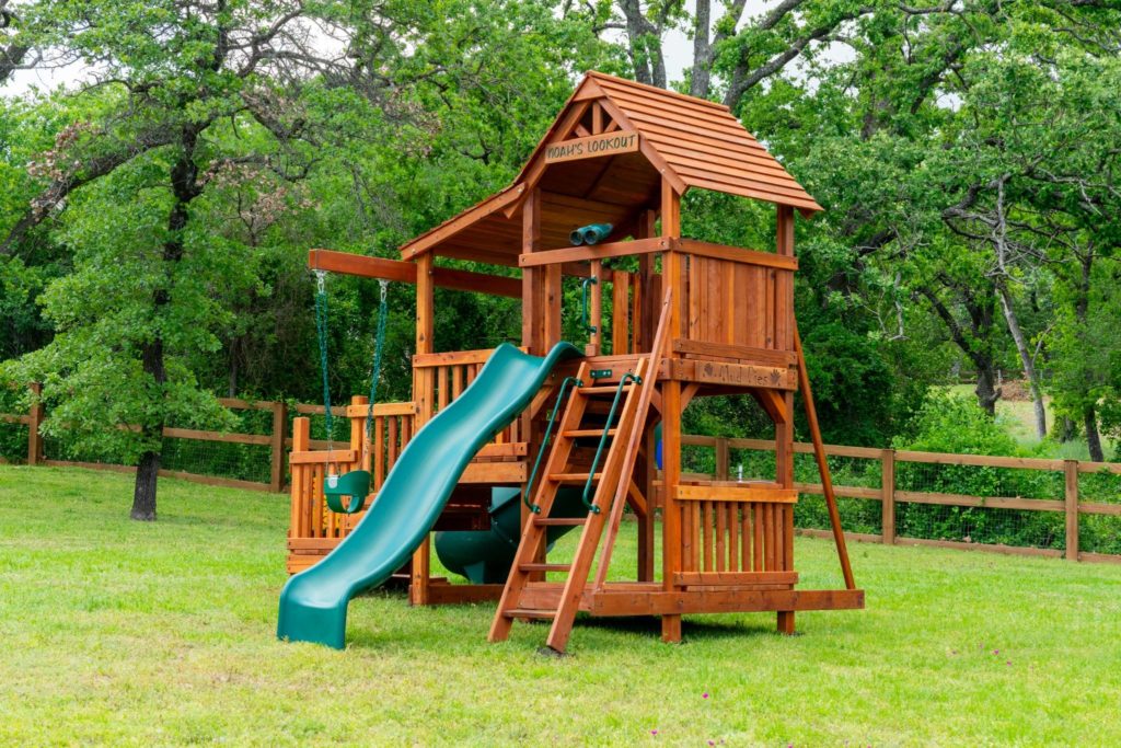 A Backyard Fun Factory playset with multiple attachments, promoting muscle growth through active play.