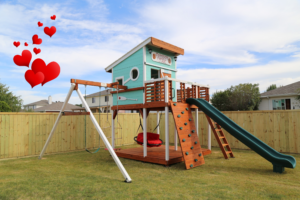 A stunning modern version of our playset, featuring a sturdy swing beam, an upper fort with a front deck, and a vibrant green wave slide.
