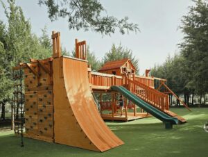 redwood swing set with warp wall for older kids. Lantana, Texas, outdoor playset with bridge slides and swings
