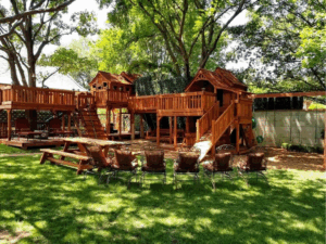 Chairs are moved around to watch the kids play on their Backyard Fun Factory playset.