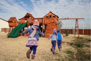 Children in winter ready to go play on their Backyard Fun Factory playset.