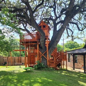 A Backyard Fun Factory custom designed playset designed around a beautiful old backyard tree.