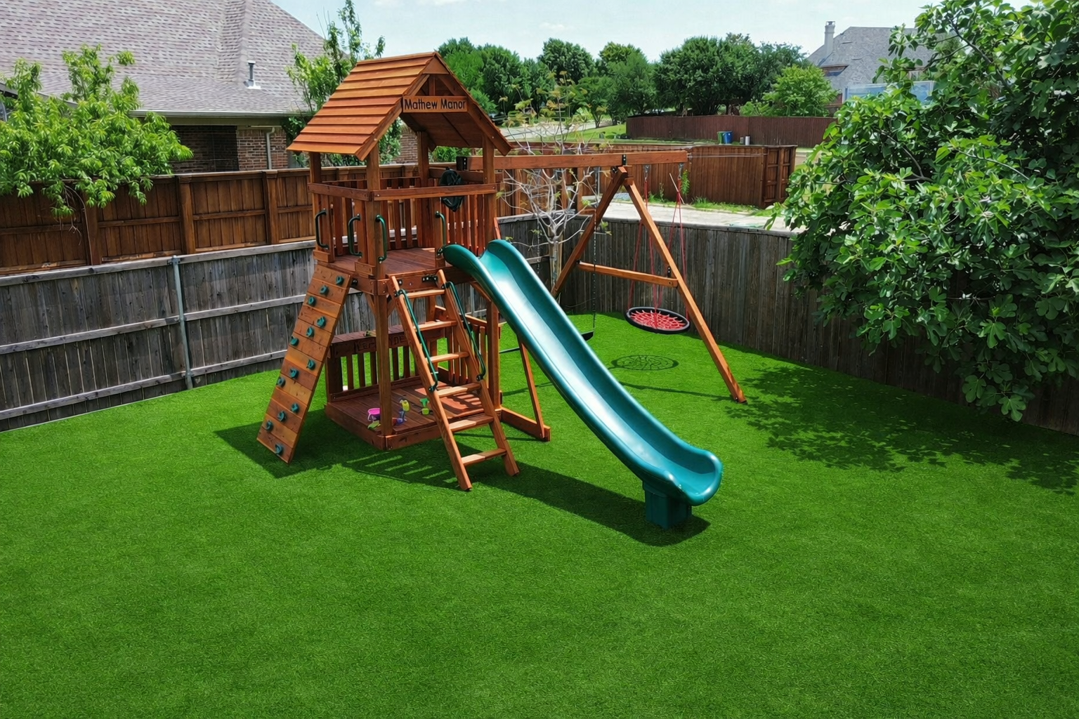 Keller, Fort Davis Playset with swings, rock wall climber and slide.