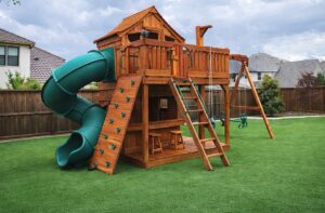 STEM learning on a backyard playset comes easy for kids. Fort Stockton swing set with upper cabin and lower cabin, enclosed spiral slide, and swings