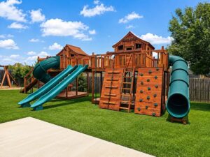 A Backyard Fun Factory playset sitting beautifully facing the porch in a large backyard.